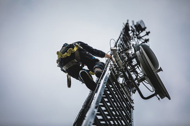 telecom-worker-climbing-antenna-tower-PEZMGB3