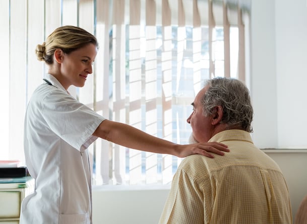 doctor-talking-to-senior-man-in-taller-home-XK7CQMP